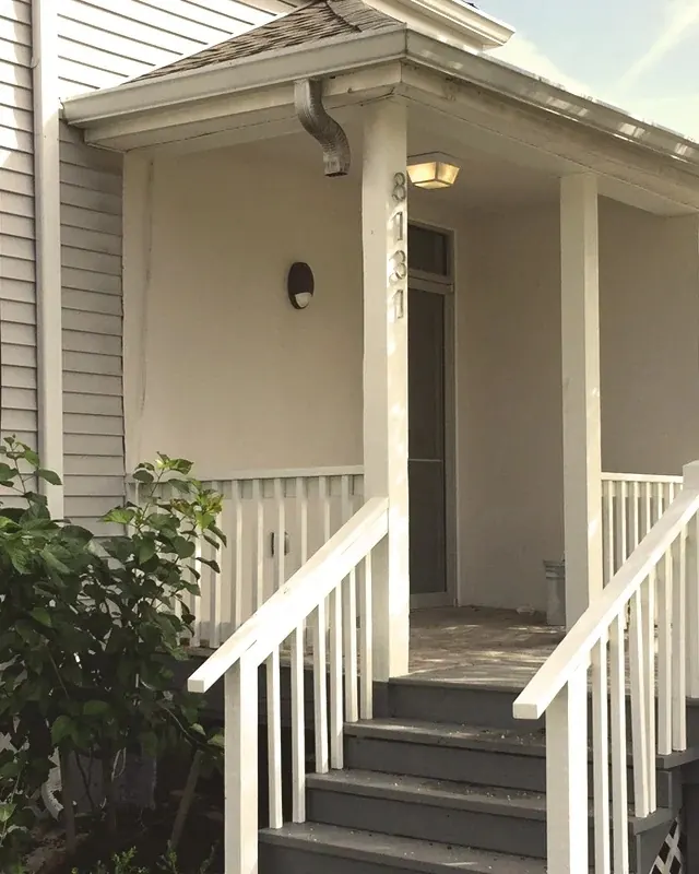 The front porch of Uptown Dental, with the house number 8131 on the porch post.